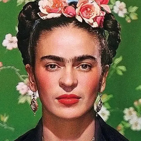 Portrait of Frida Kahlo with pink flowers in her braided hair, earrings, and red lipstick on green floral background