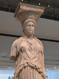 Ancient marble caryatid statue on display inside the Acropolis Museum