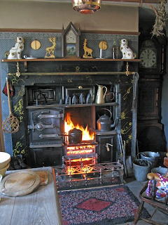 Vintage 1950s fireplace with mantel and decorative items in a cozy living room