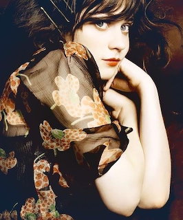 Portrait of woman with blue eyes wearing elaborate floral headpiece and vintage costume