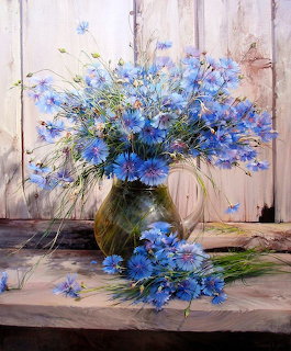 Painting of blue cornflowers in a glass vase on a wooden windowsill