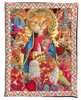 Colorful appliqué quilt of a haloed orange cat with birds, fruit, and ornate decorative patterns