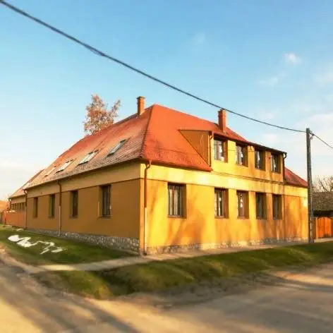 Yellow building with red tiled roof on a rural village street in Hungary