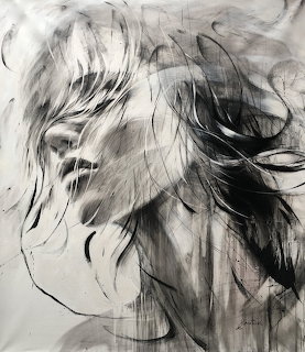 Black and white charcoal drawing of a woman's face with flowing windswept hair