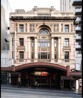 Historic Regent Theatre with ornate facade, arched entrance, and red marquee canopy