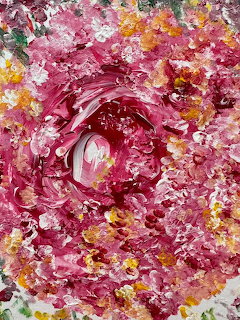 Abstract painting with pink spiral swirls and orange yellow paint splatters