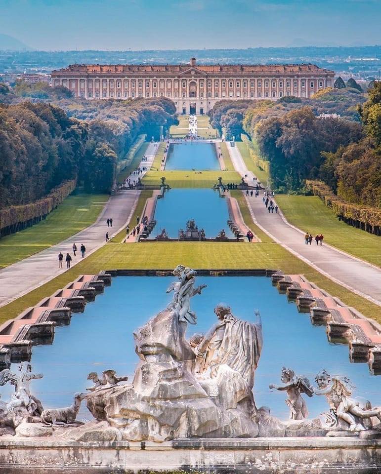 Baroque fountain and grand canal leading to the Royal Palace of Caserta with formal gardens