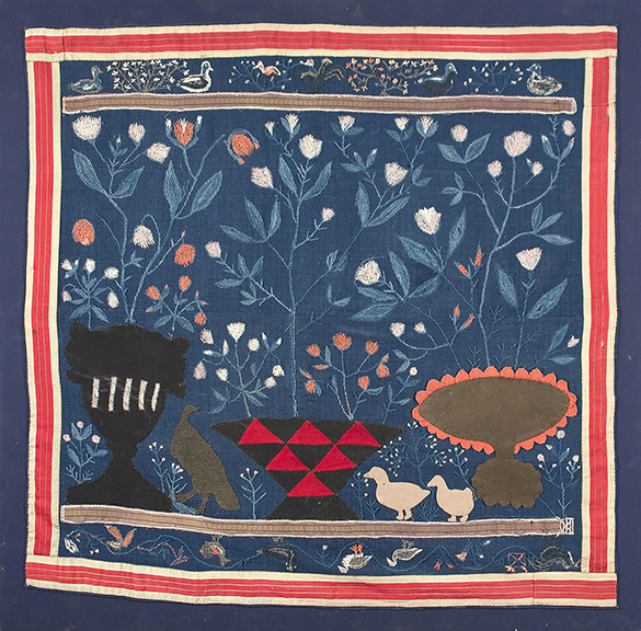 Folk-style tapestry with flowers, a dark animal silhouette, a small dog, and a tree on a blue field