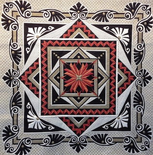 Geometric quilt with nested squares, central star, and ornate fan-shaped corner designs in black, red, and cream tones