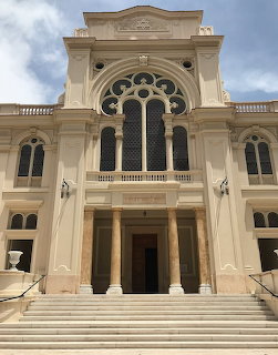Facade of Eliyahu Hanavi Synagogue in Alexandria with arched windows, columns, and broad steps