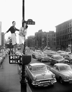 Women on Street Sign Pole