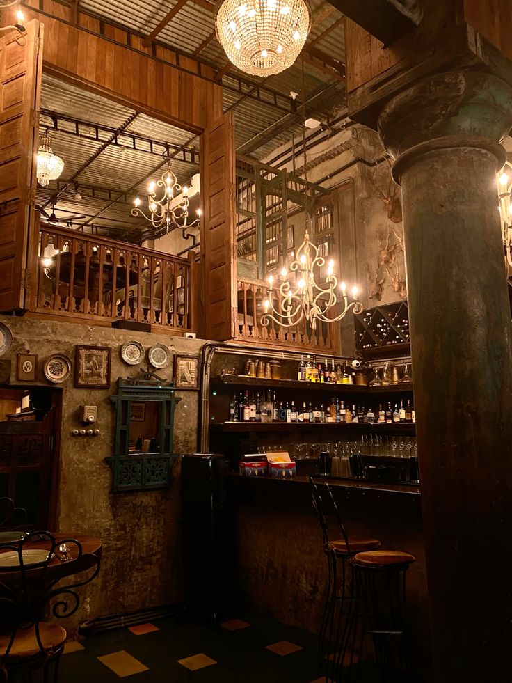 Vintage cafe interior with ornate chandeliers, wooden bar, and checkered floor in warm lighting