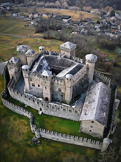 Aerial view of Fenis Castle in Italy with medieval towers and surrounding village