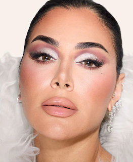Close-up portrait of woman with elegant makeup and pearl earrings