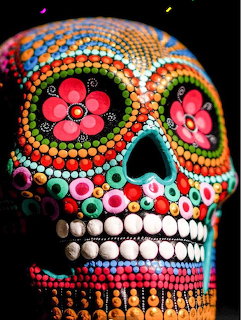 Colorful beaded sugar skull with pink flowers and rainbow patterns
