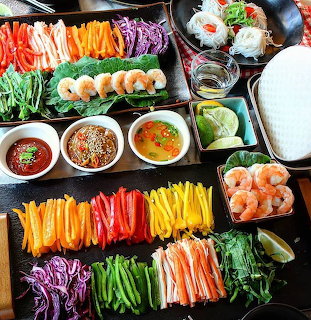 Overhead view of colorful fresh vegetable platters with dipping sauces and side dishes