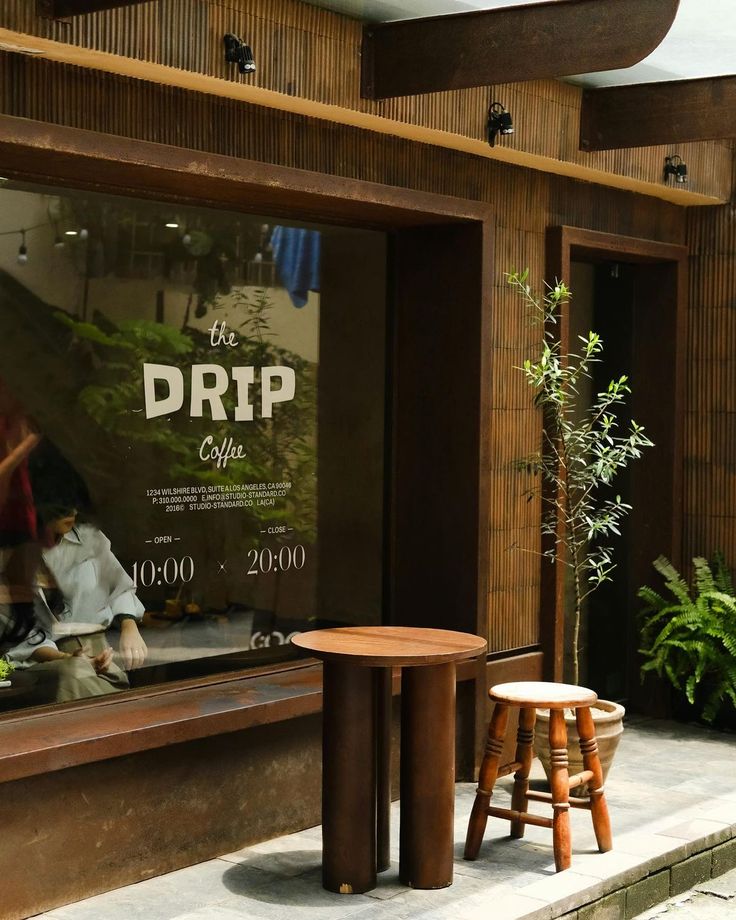 Exterior of The Drip Cafe with signage, windows, and sidewalk seating