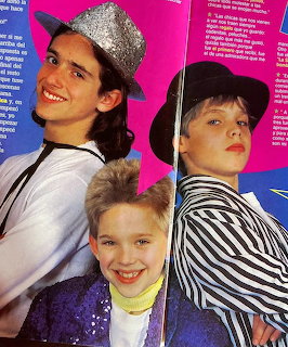 Three young actors from Chiquititas posing in hats against a pink magazine background