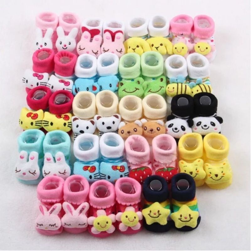 Collection of colorful baby booties with animal designs including bunnies, bears, bees, and cartoon characters