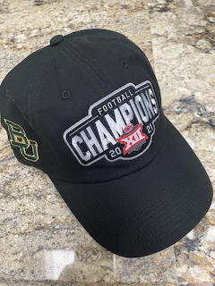 Black Baylor Bears baseball cap with Big 12 Champions 2021 patch on granite surface