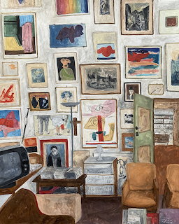 Interior room with wall covered in framed art pieces and vintage furniture
