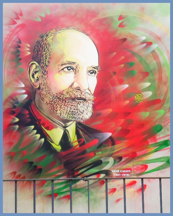 Colorful mural portrait of a bald bearded man with a red and green abstract background