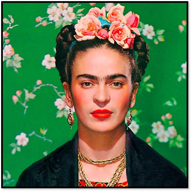 Woman wearing colorful floral crown and statement jewelry on green floral backdrop