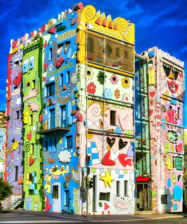 Vibrant multi-story building decorated with colorful cartoon characters and pop art designs