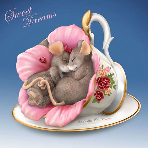 Ceramic figurine of two mice sleeping in pink flower petals inside a decorative floral teacup