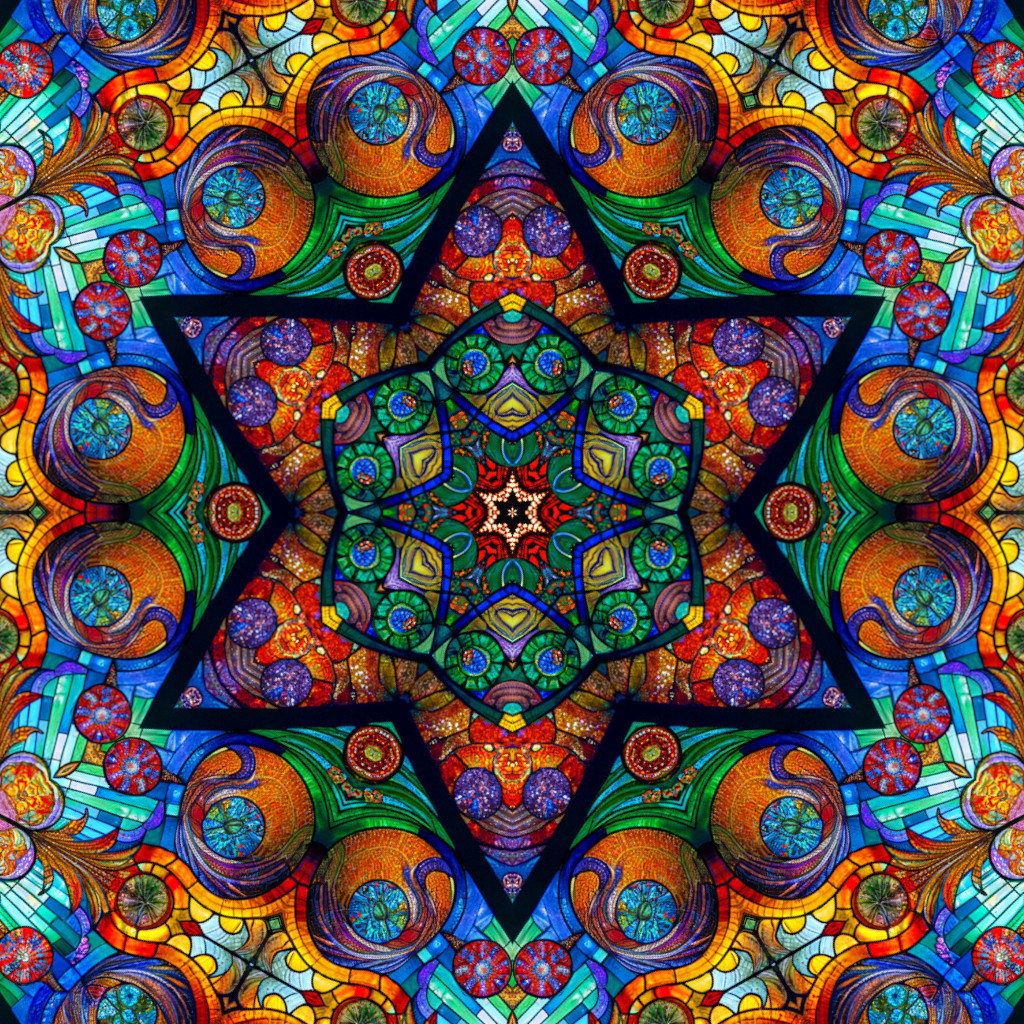 Vibrant symmetrical mandala with intricate geometric patterns in rainbow colors