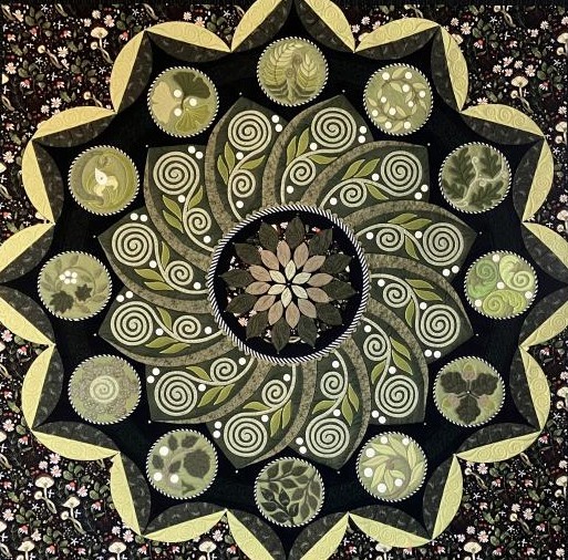 Ornate mandala with spirals and floral patterns in black and gold tones