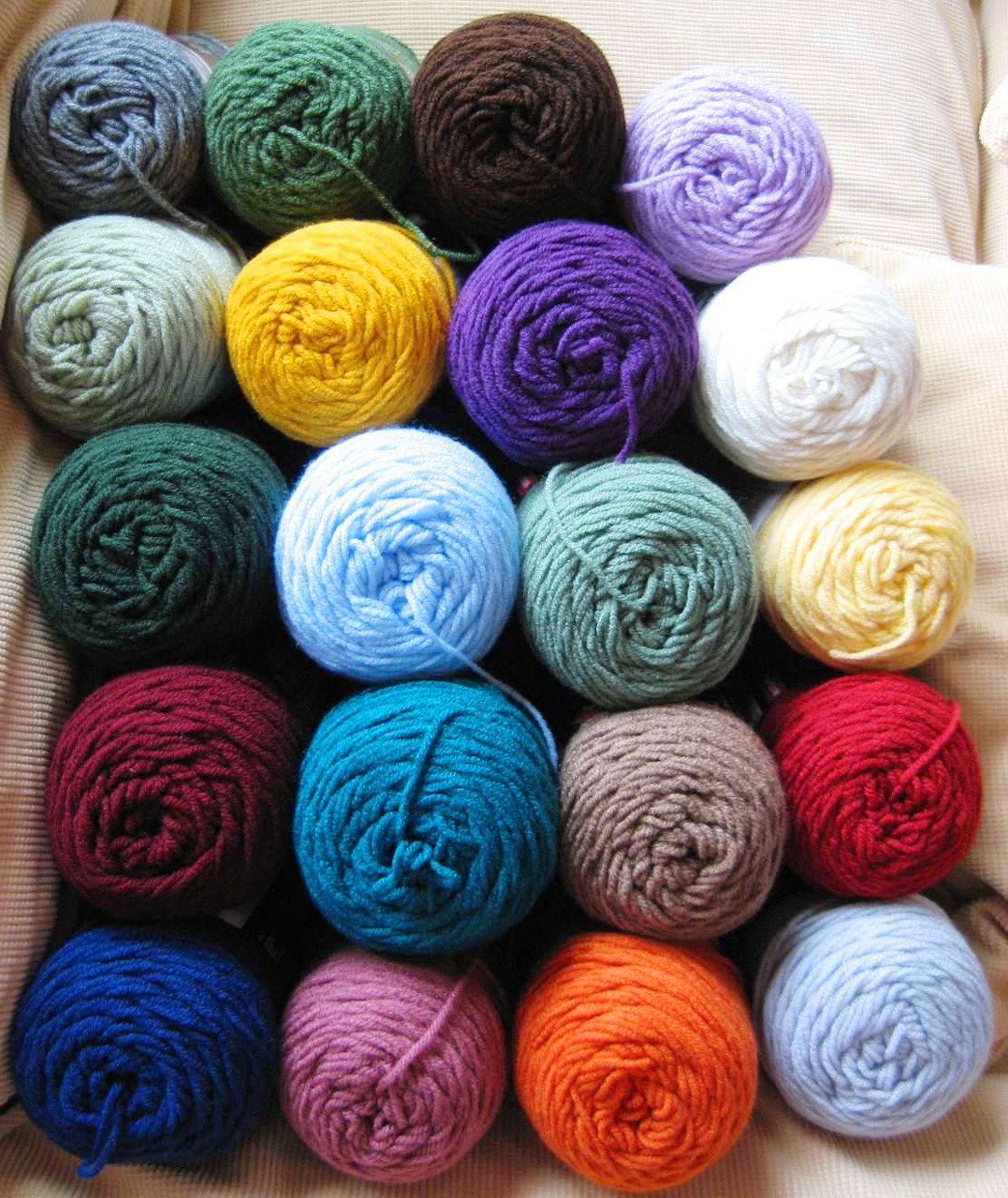 Grid of multicolored yarn balls neatly arranged in a box