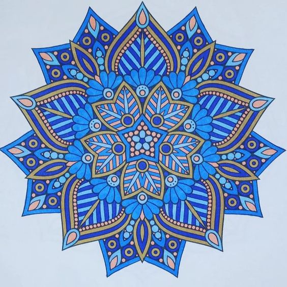 Blue mandala with symmetrical floral and geometric patterns on light background