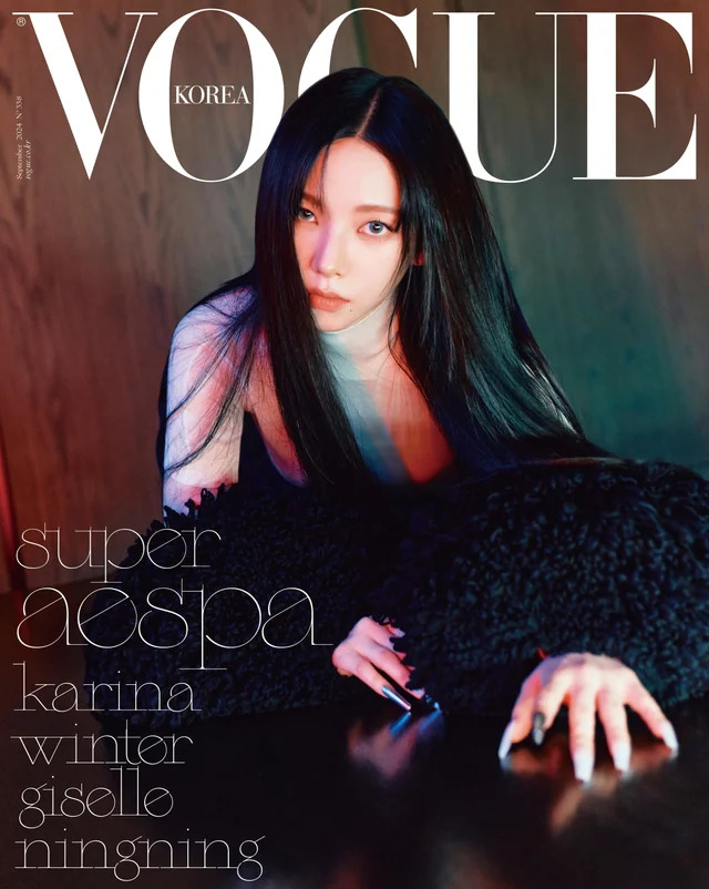 Karina from aespa on the cover of Vogue Korea magazine with long black hair in a dark editorial pose