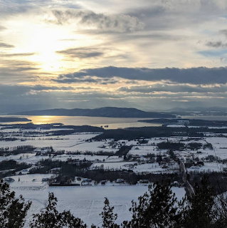 Winter landscape view from Mt Philo in Vermont with snow-covered trees and distant hills