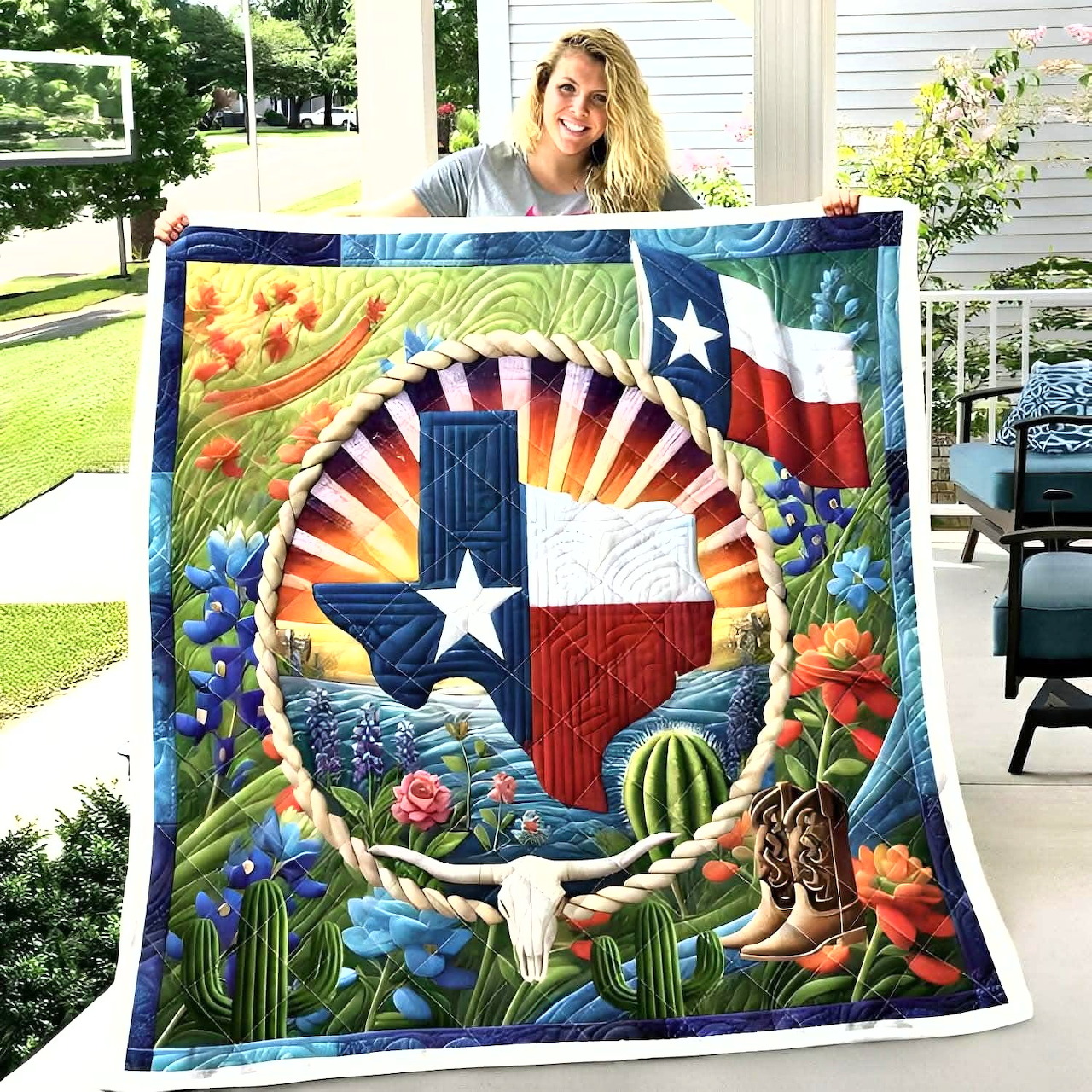 Woman holding a colorful Texas-themed quilt on a porch