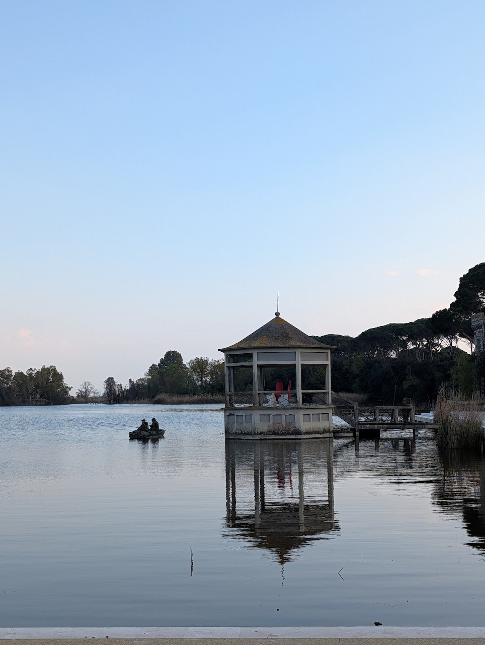 Gazebo pavilion on water with reflection at Torre del Lago at dusk