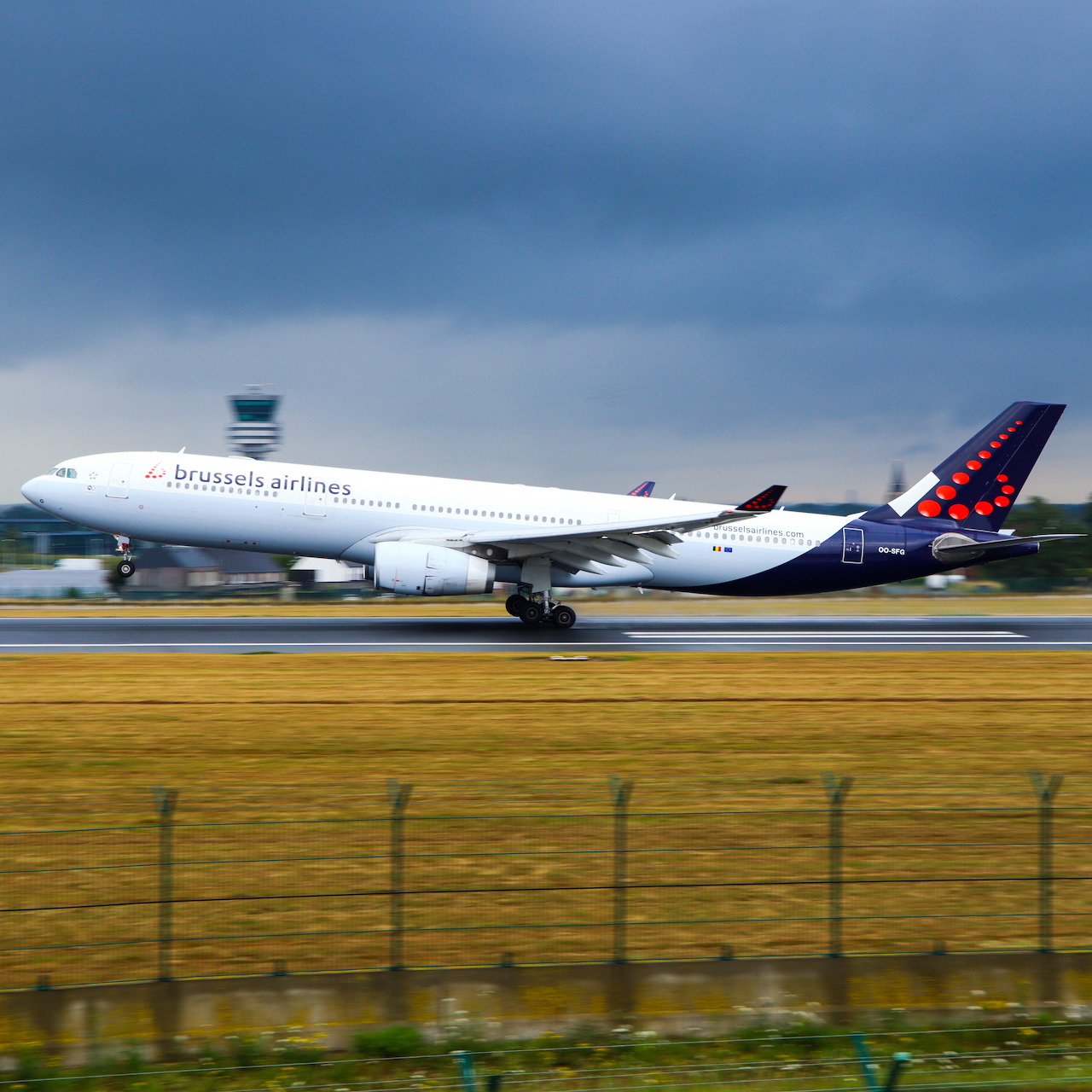 Brussels Airlines Airbus A330 aircraft on airport runway with cloudy sky
