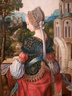 Painting of an Elizabethan woman in an ornate gown beside castle architecture and a distant landscape