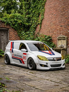 White Vauxhall number 86 rally car with red and blue stripes on a cobblestone courtyard near ivy-covered brick wall