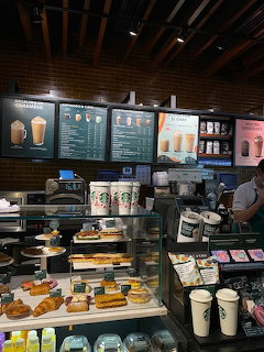 Starbucks cafe counter with menu boards and pastry display case