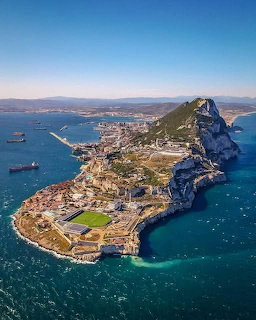 Aerial view of Gibraltar peninsula with the Rock, harbor, and coastal city