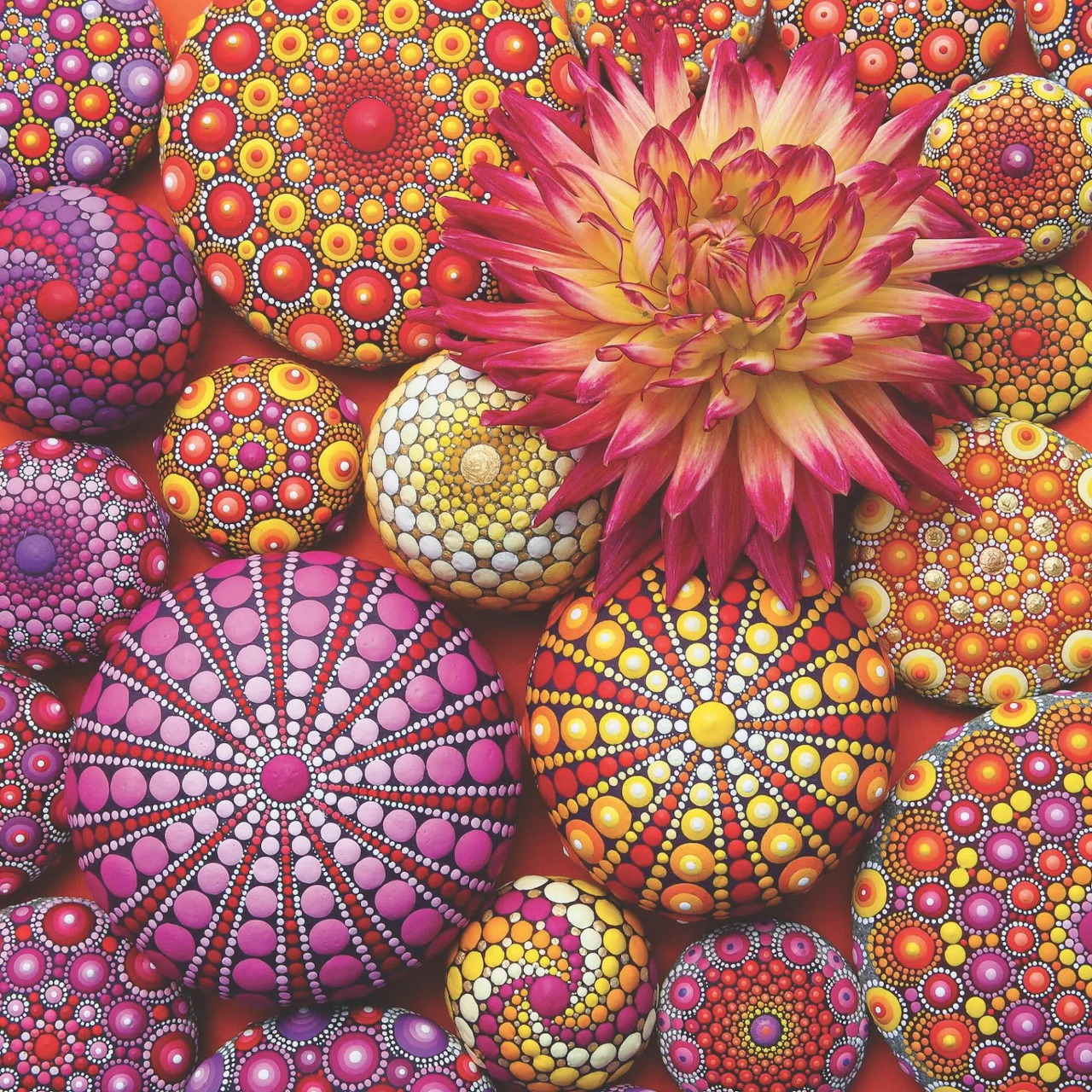 Colorful mandala art with floral and geometric circular patterns in pink, orange, and yellow tones