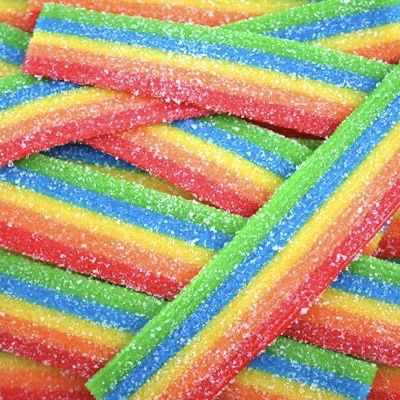 Pile of rainbow-striped sour candy sticks covered in sugar crystals