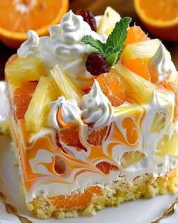 Slice of layered cake with oranges, whipped cream, and cherry garnish