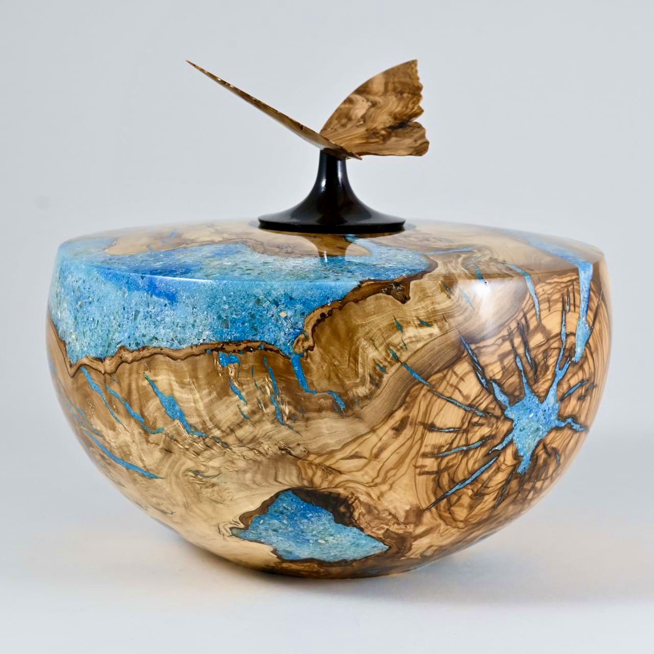 Round wooden bowl with blue resin inlay and carved butterfly on lid