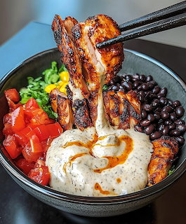 Chopsticks holding grilled chicken drumsticks over a bowl with rice, beans, tomatoes, corn, and cilantro