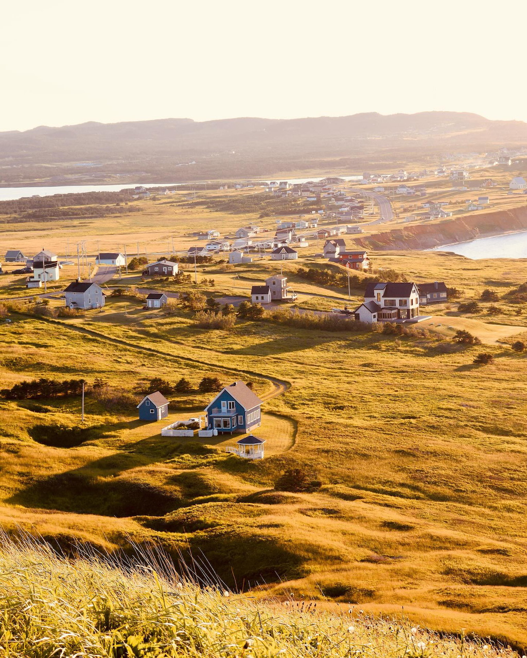 Brightly painted village houses on the Madeleine Islands coast