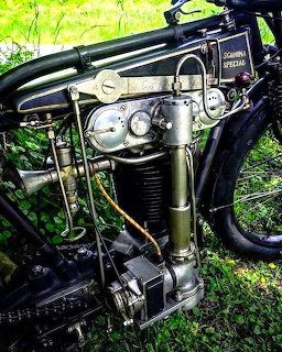 Vintage 1920s Sgonina DOHC motorcycle racing engine with exposed mechanical parts and polished metal finish