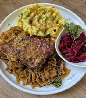 Plate of ribs with cabbage, mashed potatoes, and beet salad